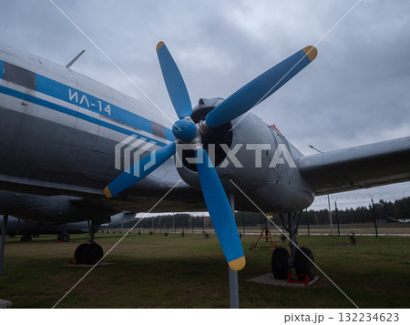 vintage aircraft exhibit featuring weathered fuselage and propellers in museum setting, display of restored antique aircraft with classic design and aged appearance under cloudy sky 132234623