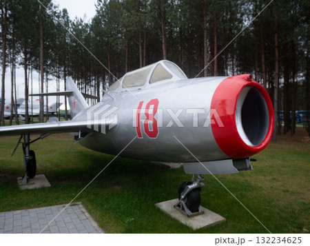 restored silver jet with red nose soaring nearby pines, restored silver jet with red nose soars near tall pines, an upgraded silver jet with red nose is flying close to towering pine trees restored silver jet with red nose soaring nearby pines, restored silver jet with red nose soars near tall pines, an upgraded silver jet with red nose is flying close to towering pine trees 132234625