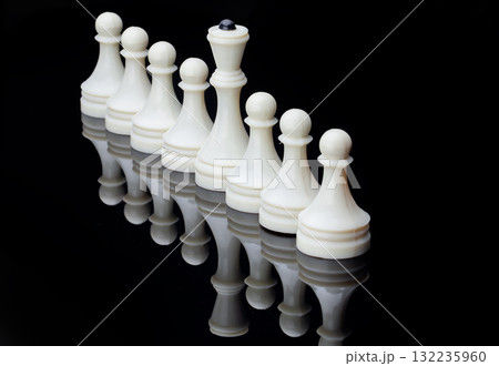 Symmetrical lineup of white chess pieces reflective surface, symbolizing strategy, balance and competition. Symmetrical lineup of white chess pieces reflective surface, symbolizing strategy, balance and competition. 132235960