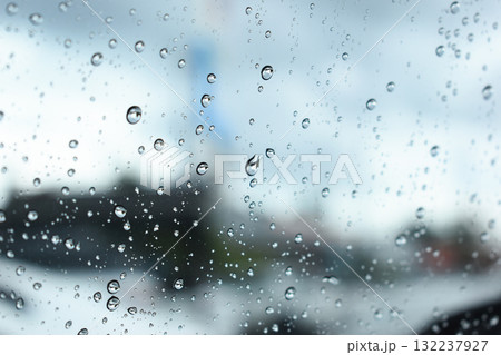 water drop on mirror in defocused car parking background water drop on mirror in defocused car parking background 132237927