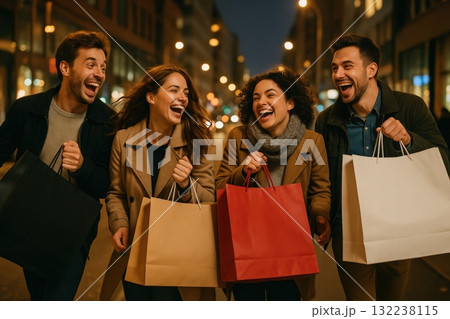 Group of friends enjoying a lively night out in the city while shopping and sharing laughter on a bustling street 132238115