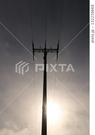 A tall power pole with three wires on top 132238668