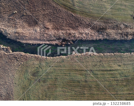Field with a river running through it 132238685