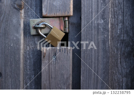 A wooden door with a lock on it 132238795