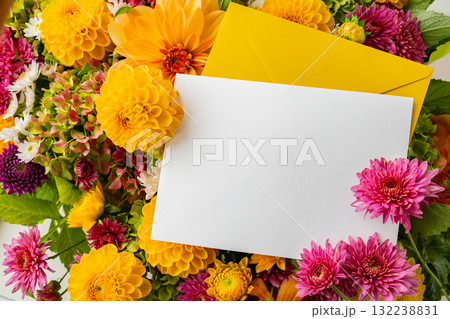 Empty white paper note copy space with yellow envelope Autumn Fall Bouquet for Thanksgiving holiday. Seasonal Warm colorful blossom flowers arrangement festive decoration. Selective 132238831
