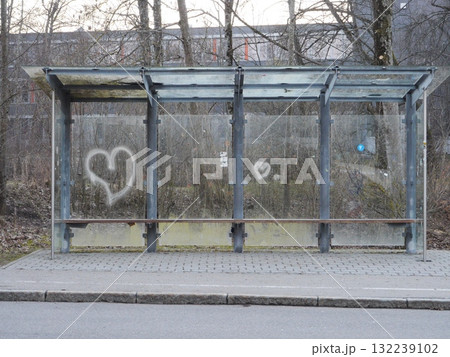 Bus stop with graffiti on the side and a heart on the wall Bus stop with graffiti on the side and a heart on the wall 132239102