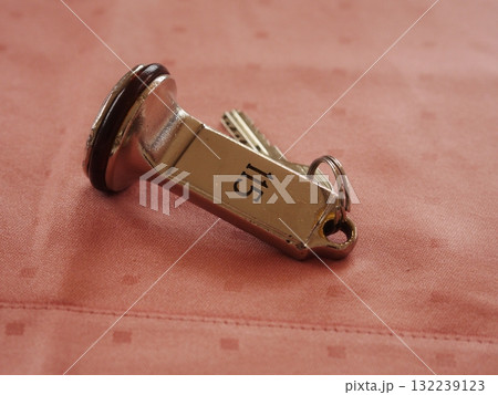 Key with the number 15 on it is laying on a table 132239123