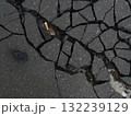 Broken sidewalk with a cigarette butt on it 132239129