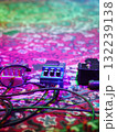Guitar pedal sits on a carpeted floor next to other pedals 132239138