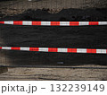 Red and white striped fence with a black background 132239149