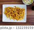 Plate of pasta with sauce on a wooden table 132239159