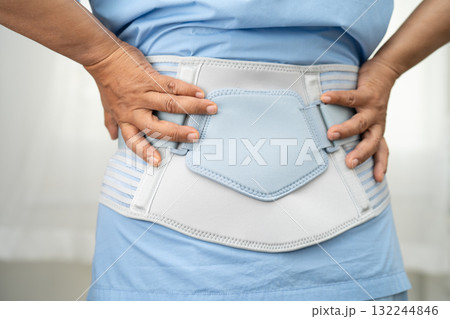 Asian lady patient wearing back pain support belt for orthopedic lumbar with walker. Asian lady patient wearing back pain support belt for orthopedic lumbar with walker. 132244846