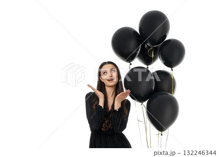 Young woman joyfully poses with black balloons, isolated, PNG Young woman joyfully poses with black balloons, isolated, PNG 132246344
