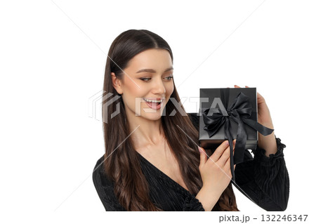 Joyful shopper with a black gift box for Black Friday, isolated, PNG Joyful shopper with a black gift box for Black Friday, isolated, PNG 132246347