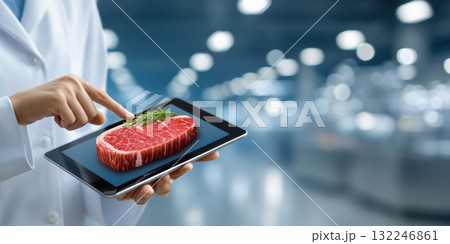 Food tech concept showing raw steak on tablet screen with herb garnish evoking innovation Food tech concept showing raw steak on tablet screen with herb garnish evoking innovation 132246861