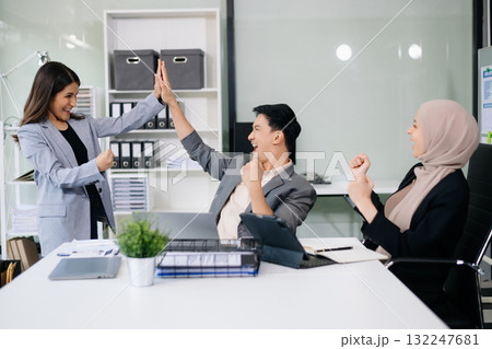 Group of young Asian business people discussing business plan at modern startup in creative business discussing work Group of young Asian business people discussing business plan at modern startup in creative business discussing work 132247681