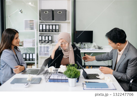 Furious Asian businesspeople arguing strongly after making a mistake at work in office Furious Asian businesspeople arguing strongly after making a mistake at work in office 132247706