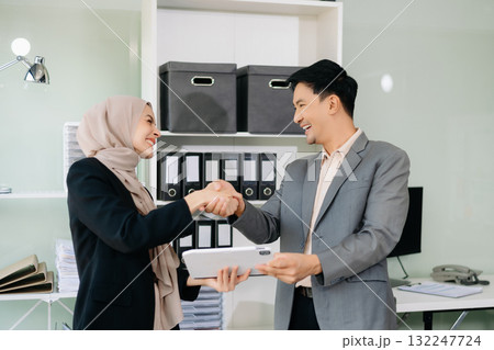 Two businesswoman and man discuss investment project working and planning strategy with tablet laptop computer Two businesswoman and man discuss investment project working and planning strategy with tablet laptop computer 132247724