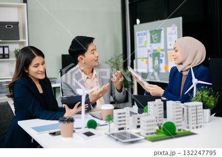 business team people planning and discussing on recycle reduce reuse policy symbol in office meeting room. Green business company and Solar Energy. business team people planning and discussing on recycle reduce reuse policy symbol in office meeting room. Green business company and Solar Energy. 132247795