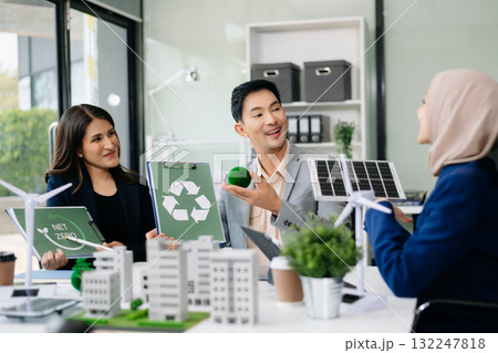 Business people having consultation about wind energy at company office. Business team discussing about windmill and alternative green enery. Net zero and carbon neutral concept 132247818