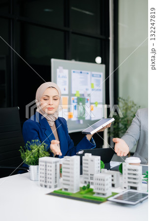 Business people having consultation about wind energy at company office. Business team discussing about windmill and alternative green enery. Net zero and carbon neutral concept 132247819