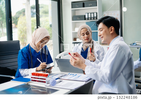 Medical professionals in modern hospital collaborating on patient care, research, and diagnosis. Doctors and nurses in hijabs discussing treatment plans, lab Medical professionals in modern hospital collaborating on patient care, research, and diagnosis. Doctors and nurses in hijabs discussing treatment plans, lab 132248186
