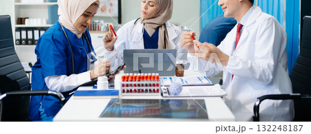 Medical professionals in modern hospital collaborating on patient care, research, and diagnosis. Doctors and nurses in hijabs discussing treatment plans, lab Medical professionals in modern hospital collaborating on patient care, research, and diagnosis. Doctors and nurses in hijabs discussing treatment plans, lab 132248187
