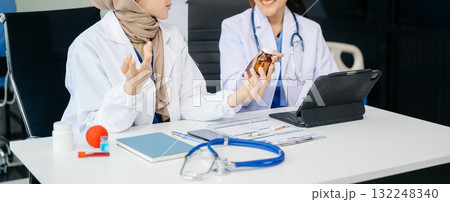 Doctor Talks With Professional Head Nurse or Surgeon, They Use Digital tablet Computer. Diverse Team of Health Care Specialists 132248340