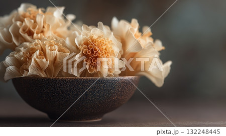 Delicate Floral Arrangements in Rustic Bowl with Soft Lighting 132248445