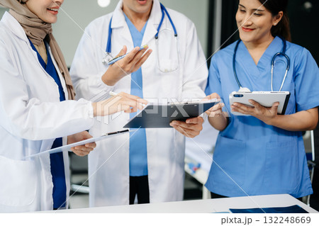 Medical professionals in modern clinic, discussing treatment and prescriptions. Healthcare, teamwork, consultation, diagnosis, and therapy and people team Medical professionals in modern clinic, discussing treatment and prescriptions. Healthcare, teamwork, consultation, diagnosis, and therapy and people team 132248669