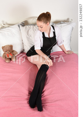 Attractive redhead model dressed as a fantasy St Trinians schoolgirl Attractive redhead model dressed as a fantasy St Trinians schoolgirl 132249857