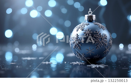 Bright blue Christmas ornament with snowflakes on a reflective surface surrounded by soft glowing lights Bright blue Christmas ornament with snowflakes on a reflective surface surrounded by soft glowing lights 132250013
