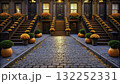 Autumn decoration in a charming street with pumpkins and flowers in brownstone homes 132252331
