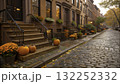 Charming autumn street lined with pumpkins and fall flowers in a historic neighborhood  132252332