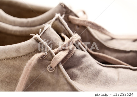 Old worn fabric shoes with laces close up 132252524