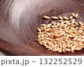 Cat grass seeds in a brown wooden bowl close up 132252529