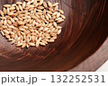 Catnip seeds in wooden textured brown bowl close up 132252531