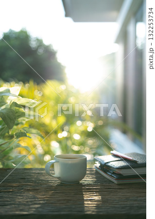 Brown coffee and leather notebooks on brown wooden table 132253734