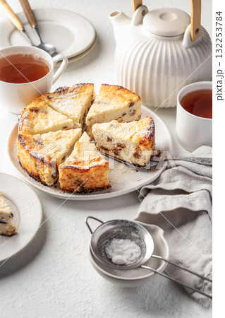 Homemade cottage cheese casserole pie with raisins. Baked cheesecake for healthy breakfast on white table background 132253784