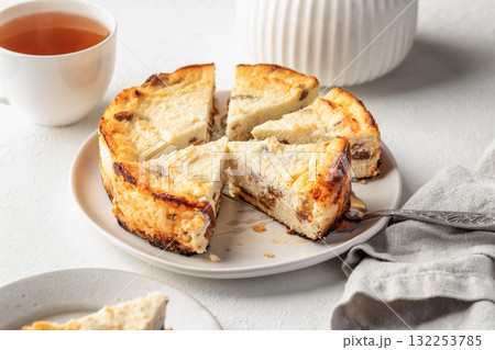 Homemade cottage cheese casserole pie with raisins. Baked cheesecake for healthy breakfast on white table background 132253785