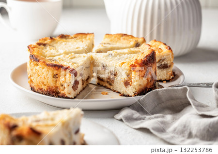 Homemade cottage cheese casserole pie with raisins. Baked cheesecake for healthy breakfast on white table background 132253786