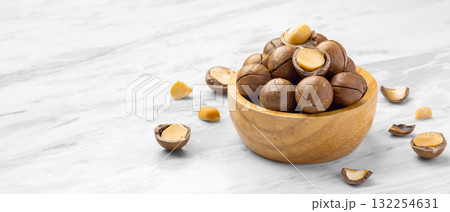 Macadamia nuts in wood bowl with broken macadamia on marble table background 132254631