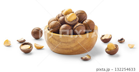 Macadamia nuts in wooden bowl with broken macadamia isolated on white background Macadamia nuts in wooden bowl with broken macadamia isolated on white background 132254633