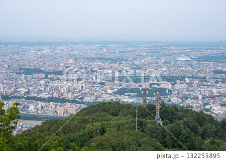 Panoramic view from Moiwa mountain, Cityscape view from green hill with communication towers in urban area at Sapporo, Hokkaido, Japan 132255895