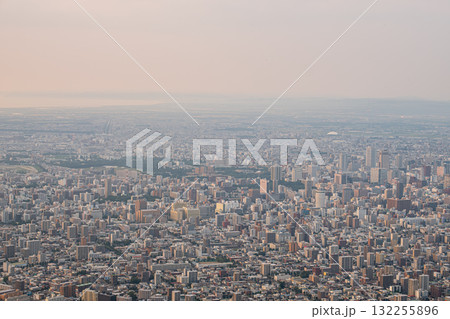 Panoramic view from Moiwa mountain, Aerial view of dense urban cityscape with buildings and skyline at sunset at Sapporo, Hokkaido, Japan 132255896