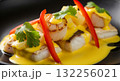 A mouth-watering, extreme close-up shot of a beautifully presented Peruvian-style seafood dish, likely a vibrant ceviche or a saute, showcasing the fresh, colourful ingredients 132256021