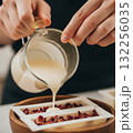 Natural ingredients like oats, lavender, and calendula are scattered on the wooden table, highlighting the use of organic components in this DIY soap making workshop 132256035