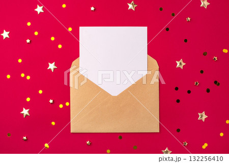 An empty white postcard in a covert on a red background 132256410