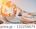 Beach Laptop Work Couple - Man and woman work on laptop while relaxing on beach chairs. 132256674