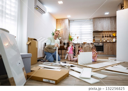 Family bonding through home assembly activity in a cozy kitchen Family bonding through home assembly activity in a cozy kitchen 132256825